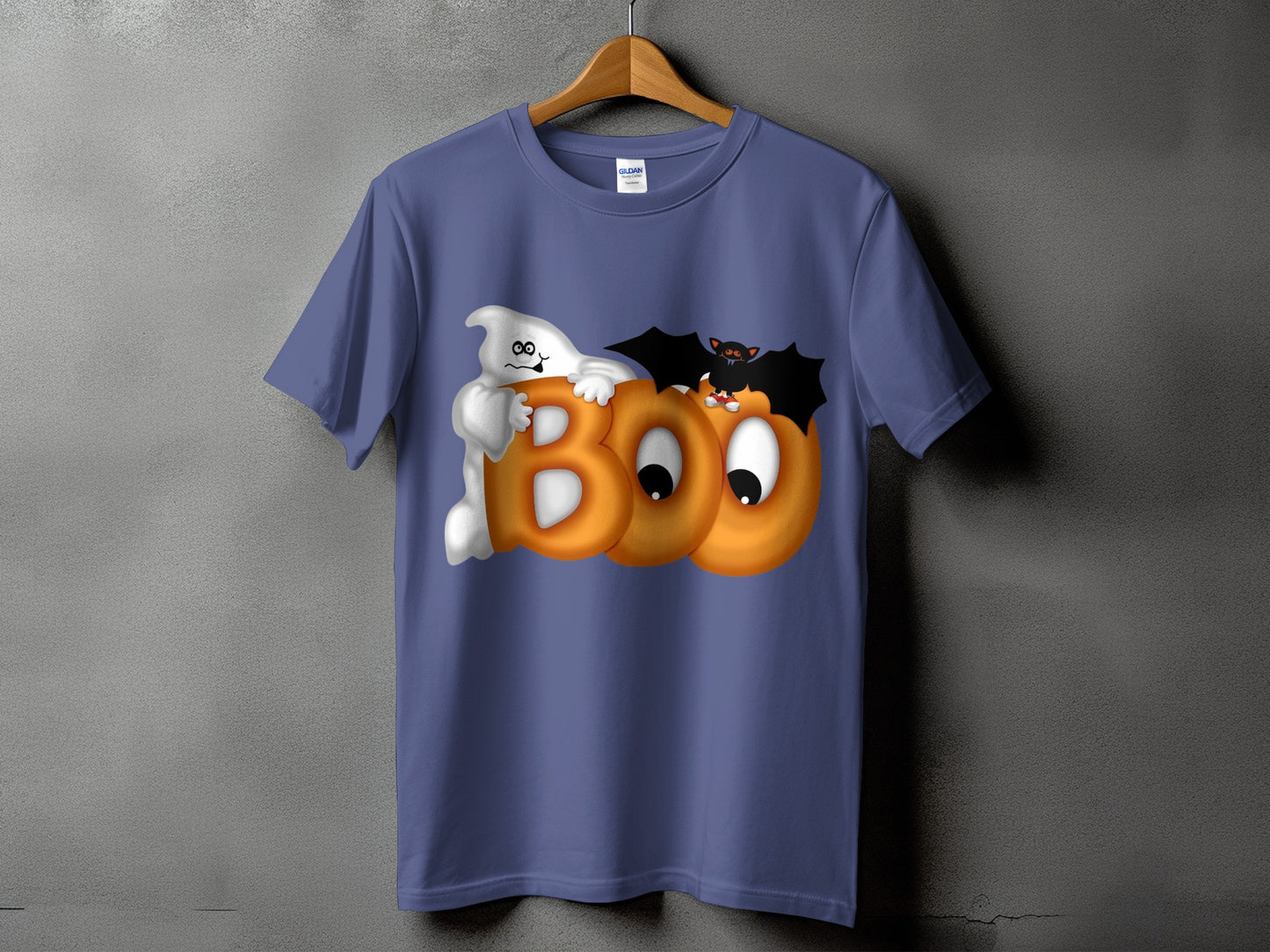Ghost and bat on shirt with text "BOO" made of pumpkins.