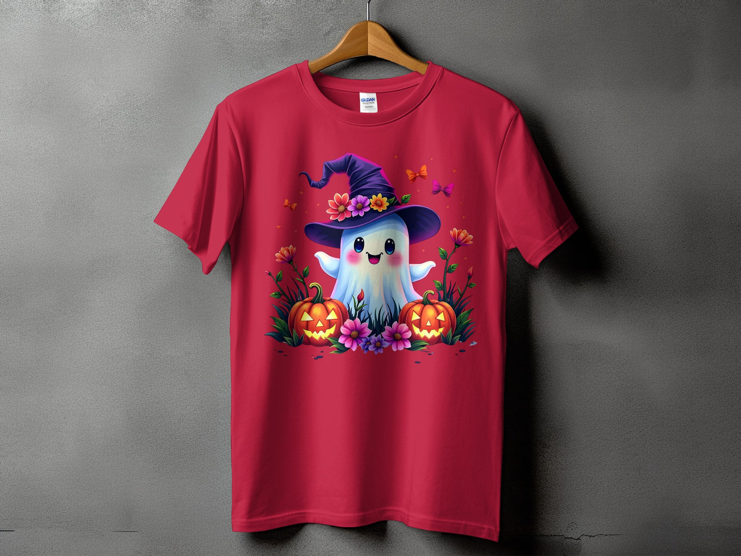 Red t-shirt with a happy ghost wearing a witch hat and surrounded by pumpkins and flowers.