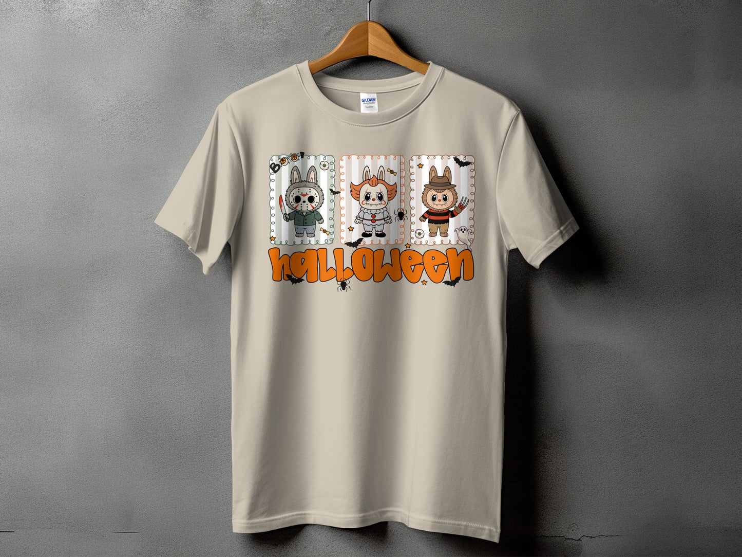Light tan t-shirt with Halloween graphic featuring three cartoon characters and "Halloween" text.