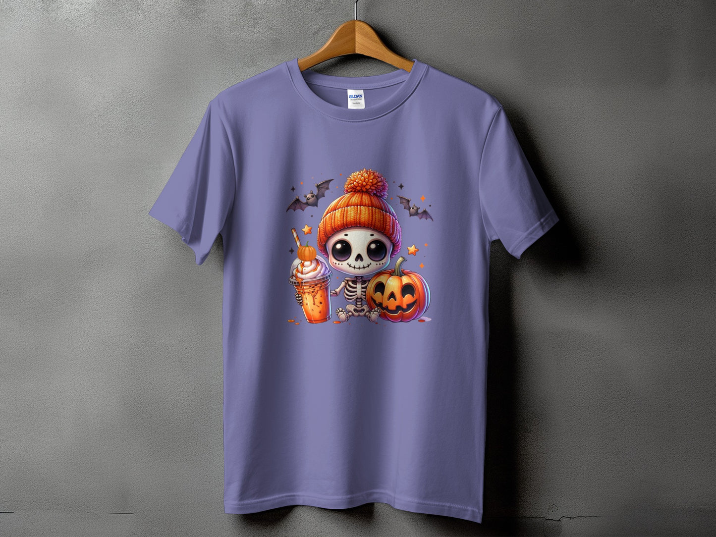 Cute skeleton in pumpkin hat with latte and pumpkin on purple t-shirt.