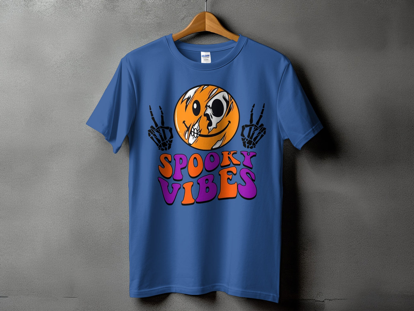Blue t-shirt with a cracked smiley face and skeleton hands, text "SPOOKY VIBES".