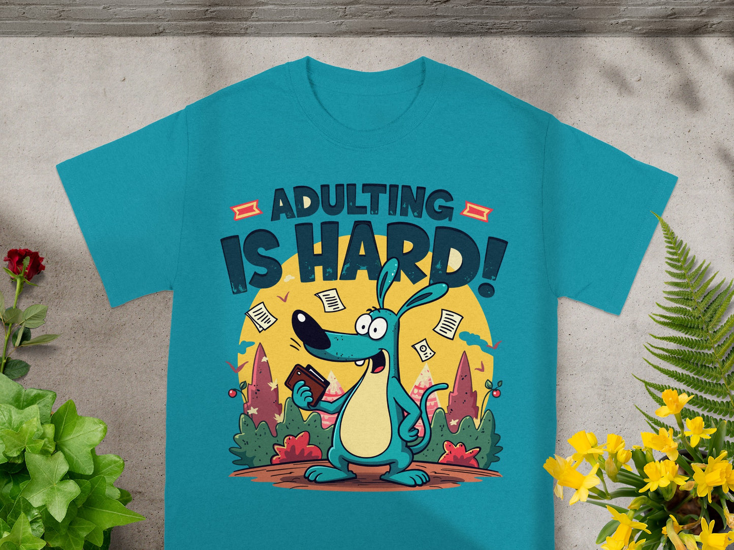 Turquoise t-shirt with quote "ADULTING IS HARD!" and cartoon dog holding wallet.