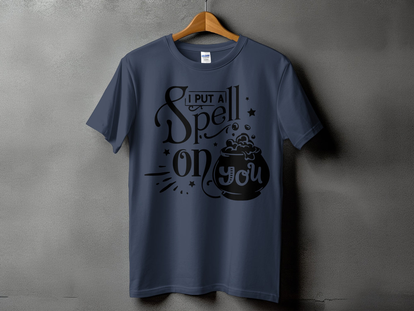 Navy t-shirt with black text and cauldron graphic reading "I put a spell on you."