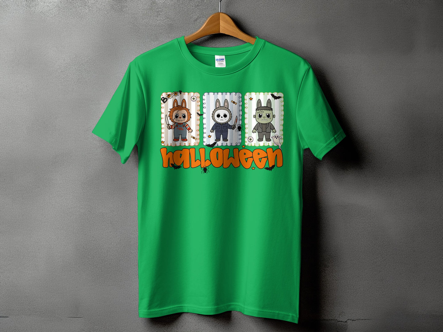 Green t-shirt with cartoon Halloween characters and text.