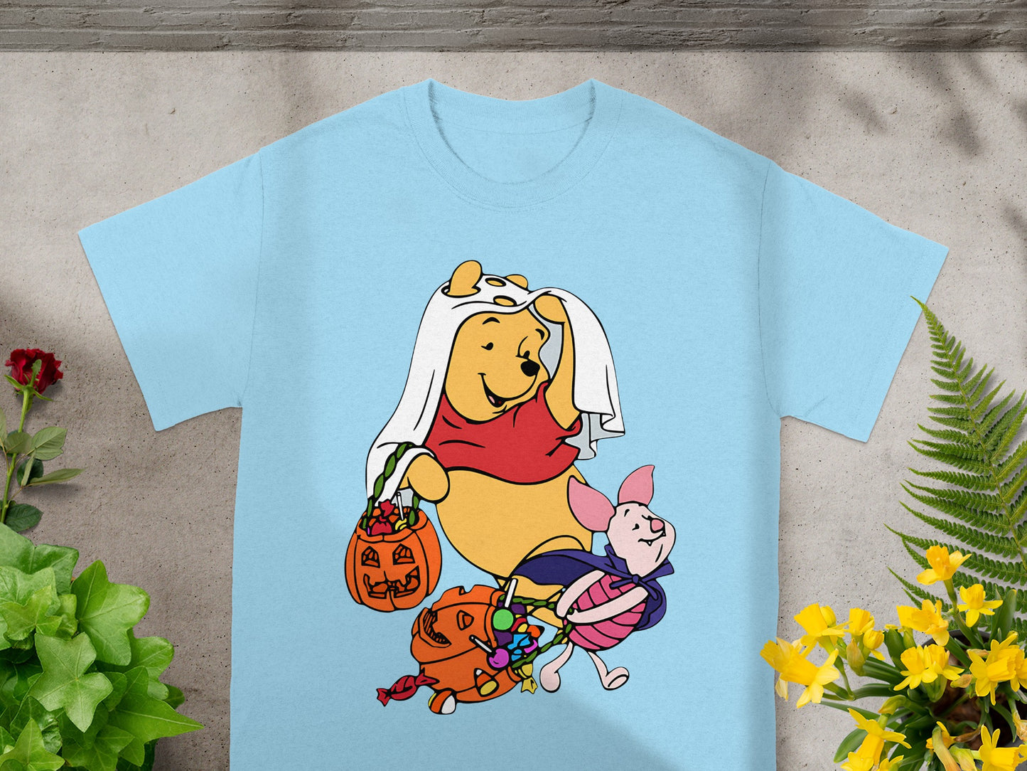 Winnie the Pooh and Piglet in Halloween costumes holding candy bags.