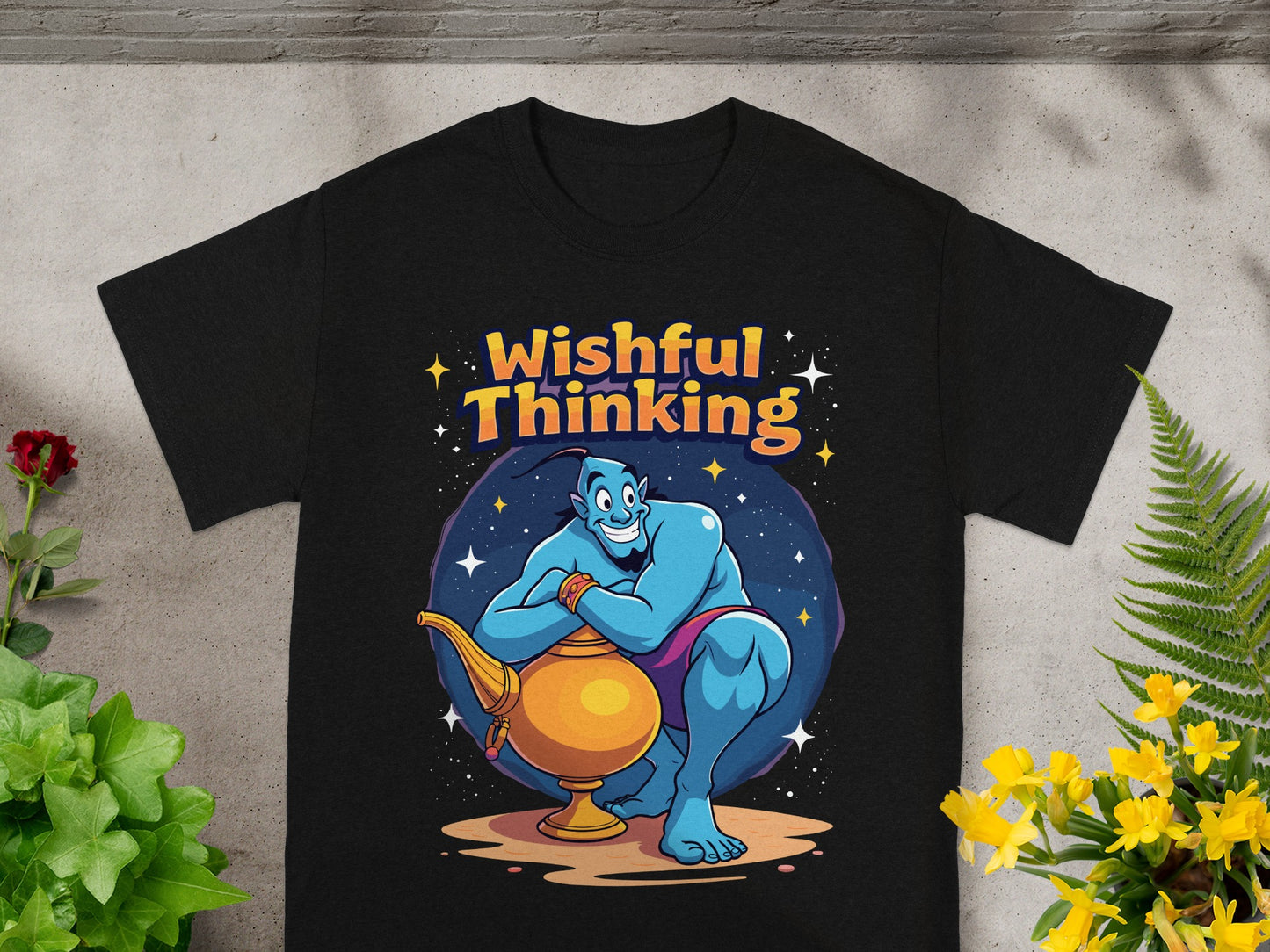 Black t-shirt with a cartoon genie holding a golden lamp, text reads "Wishful Thinking".