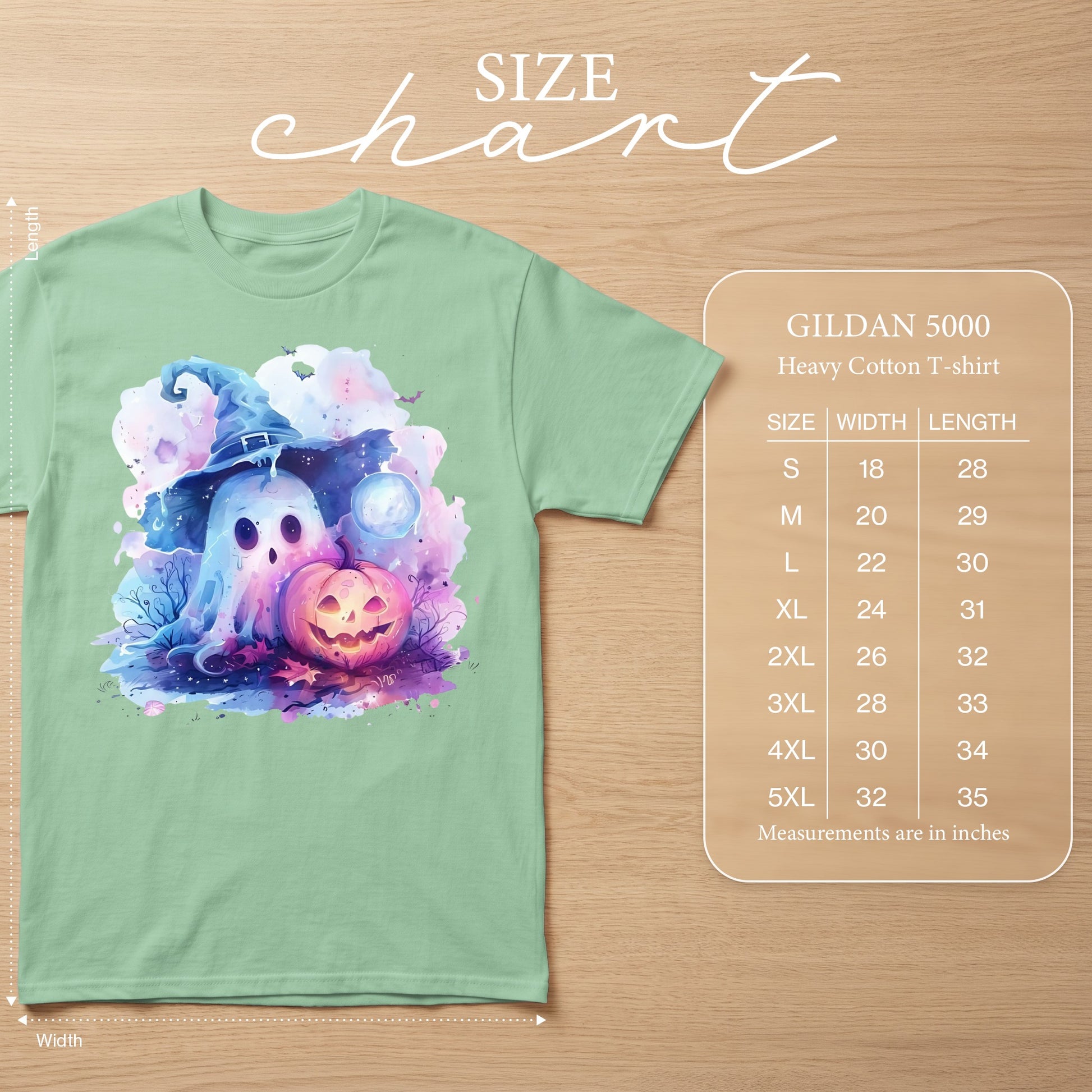 Mint green t-shirt with watercolor ghost, witch hat, pumpkin, and moon graphic. Size chart included.