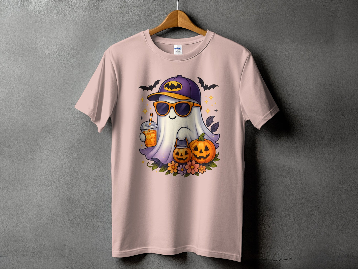 Halloween ghost with sunglasses, drink, pumpkins, and bats on a pink t-shirt.