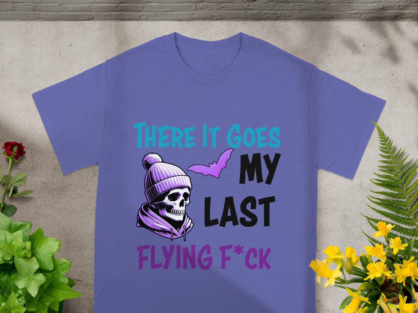 Purple t-shirt with skull, bat, and text "THERE IT GOES MY LAST FLYING F*CK".