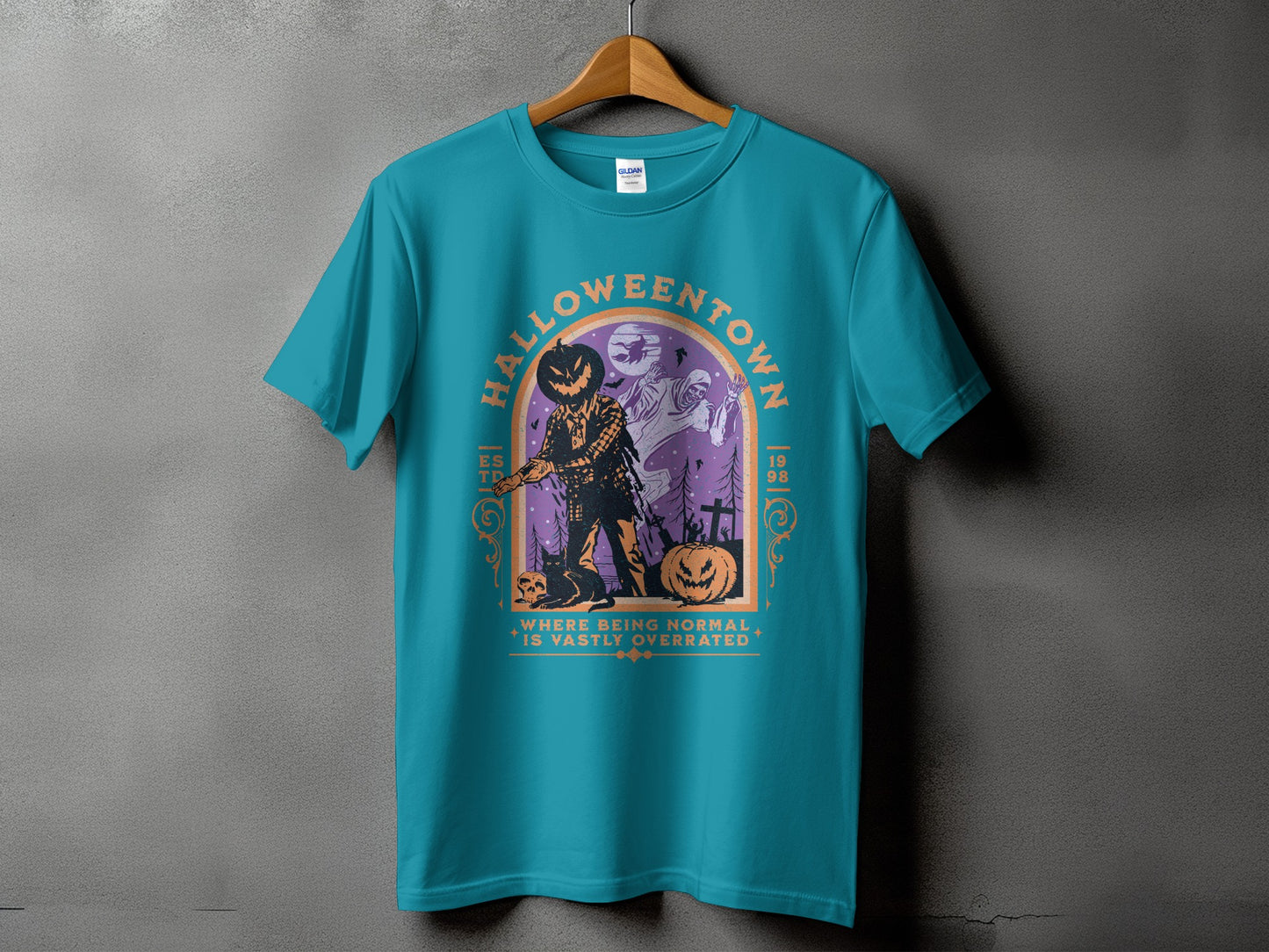 Teal t-shirt with Halloweentown graphic featuring scarecrow, ghost, and pumpkin.