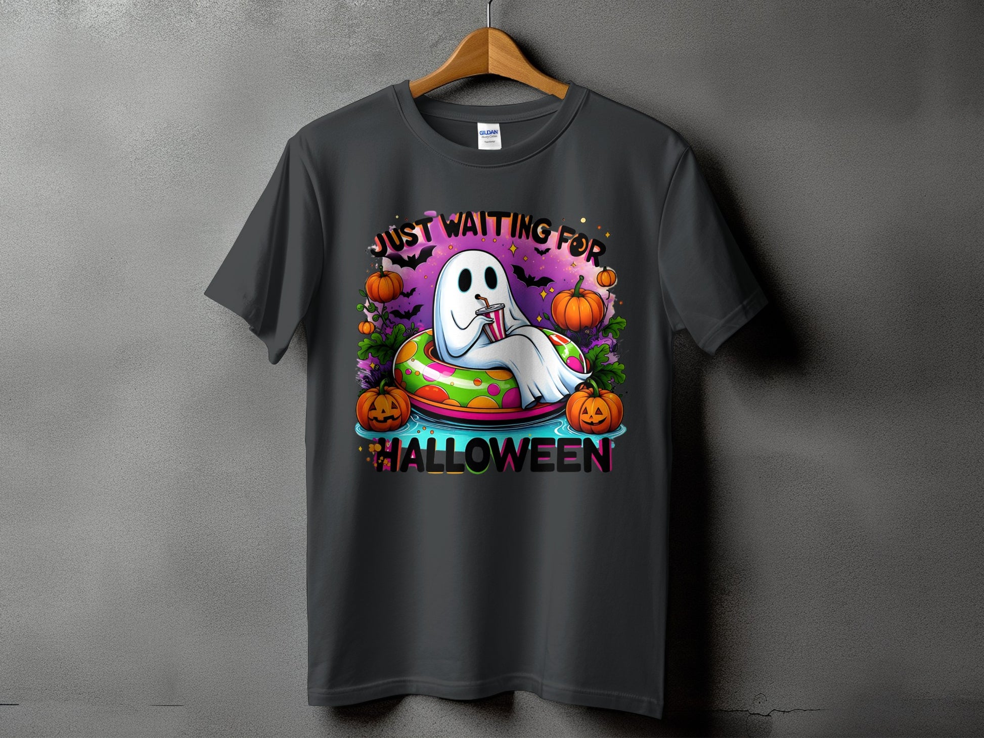 Ghost in a float with pumpkins, bats, and text "JUST WAITING FOR HALLOWEEN".