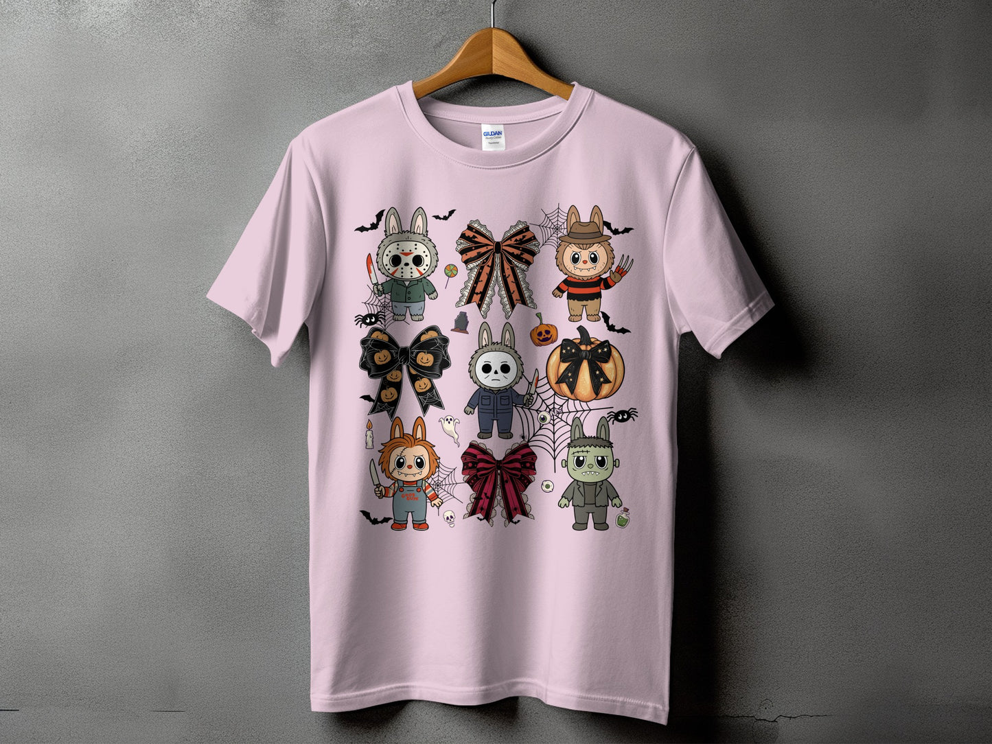 Pink t-shirt with a collage of cute Halloween-themed characters and bows.