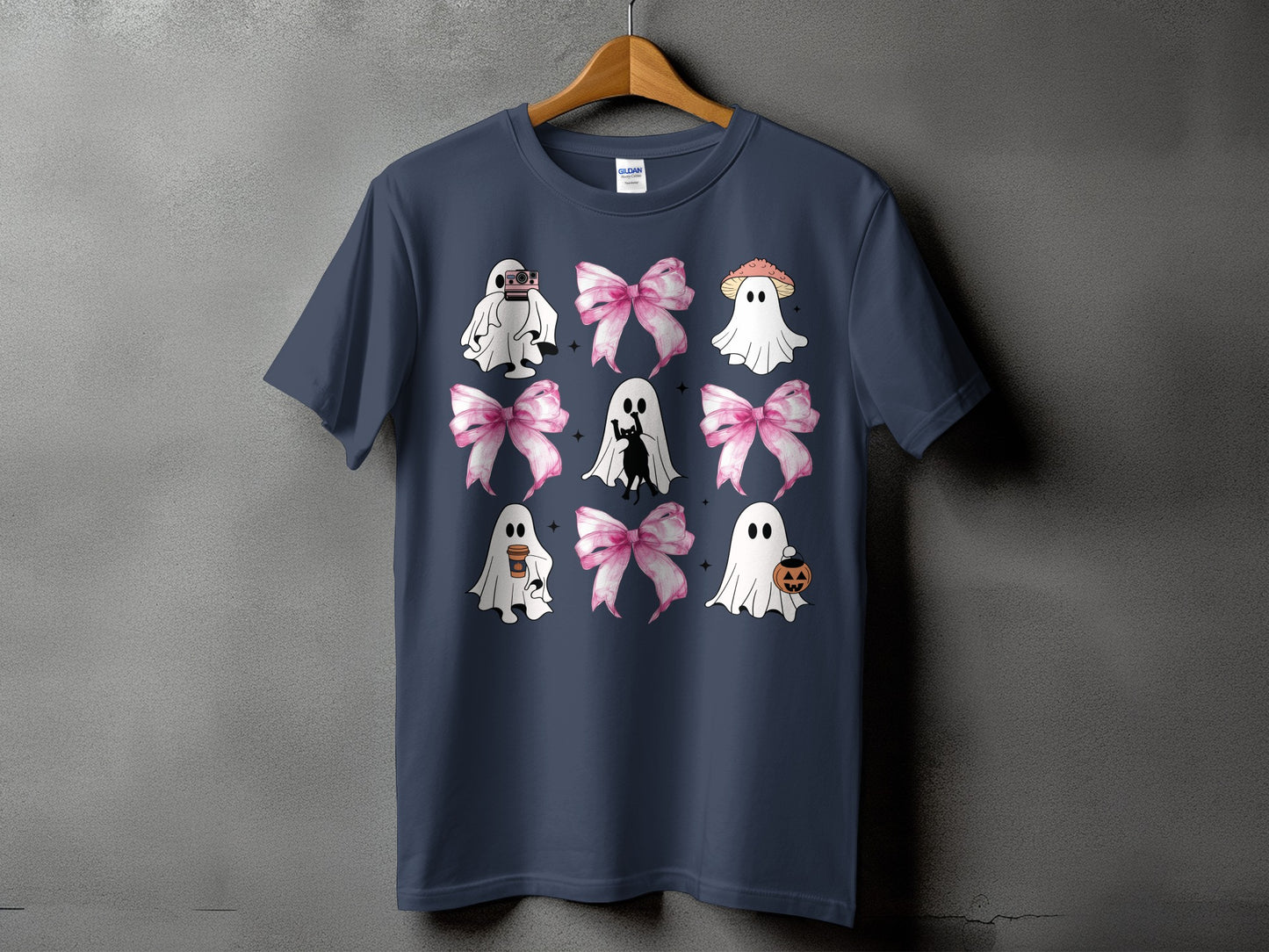 Dark navy t-shirt with a nine-panel graphic of ghosts, bows, and Halloween elements.