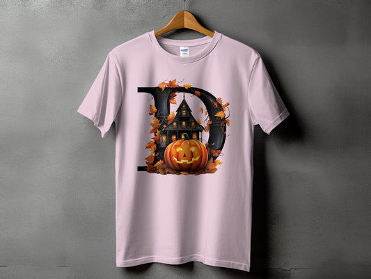 Pink t-shirt with a large letter D graphic featuring a haunted house and pumpkin.