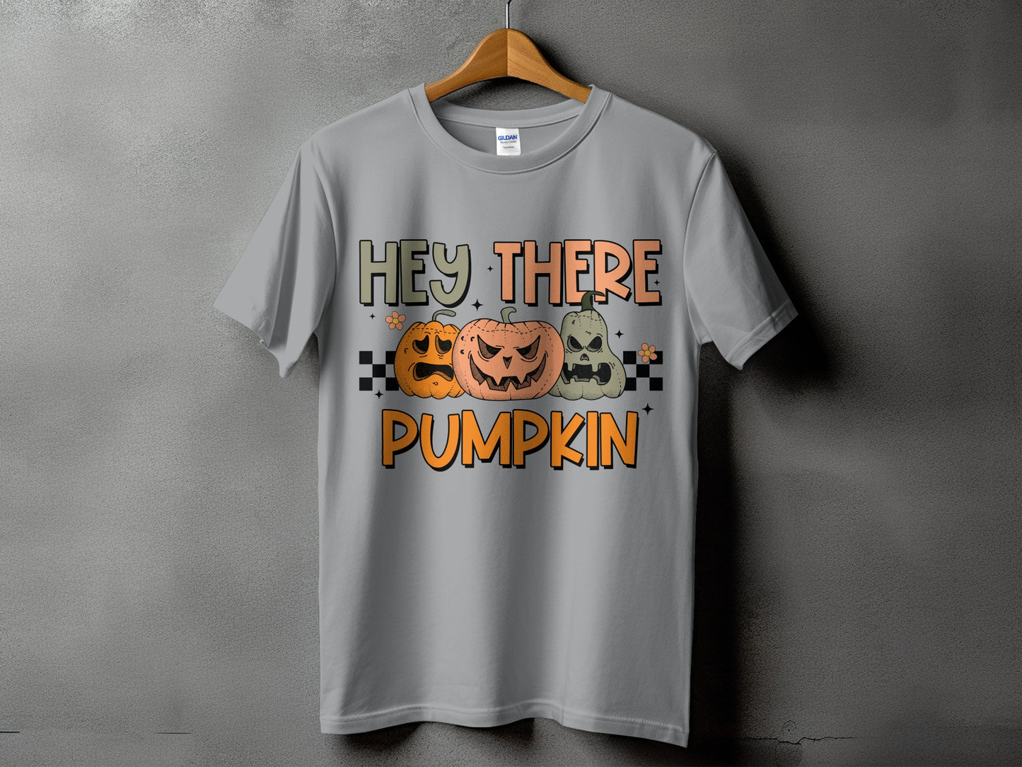 Grey t-shirt with text "HEY THERE PUMPKIN" and three jack-o'-lanterns.