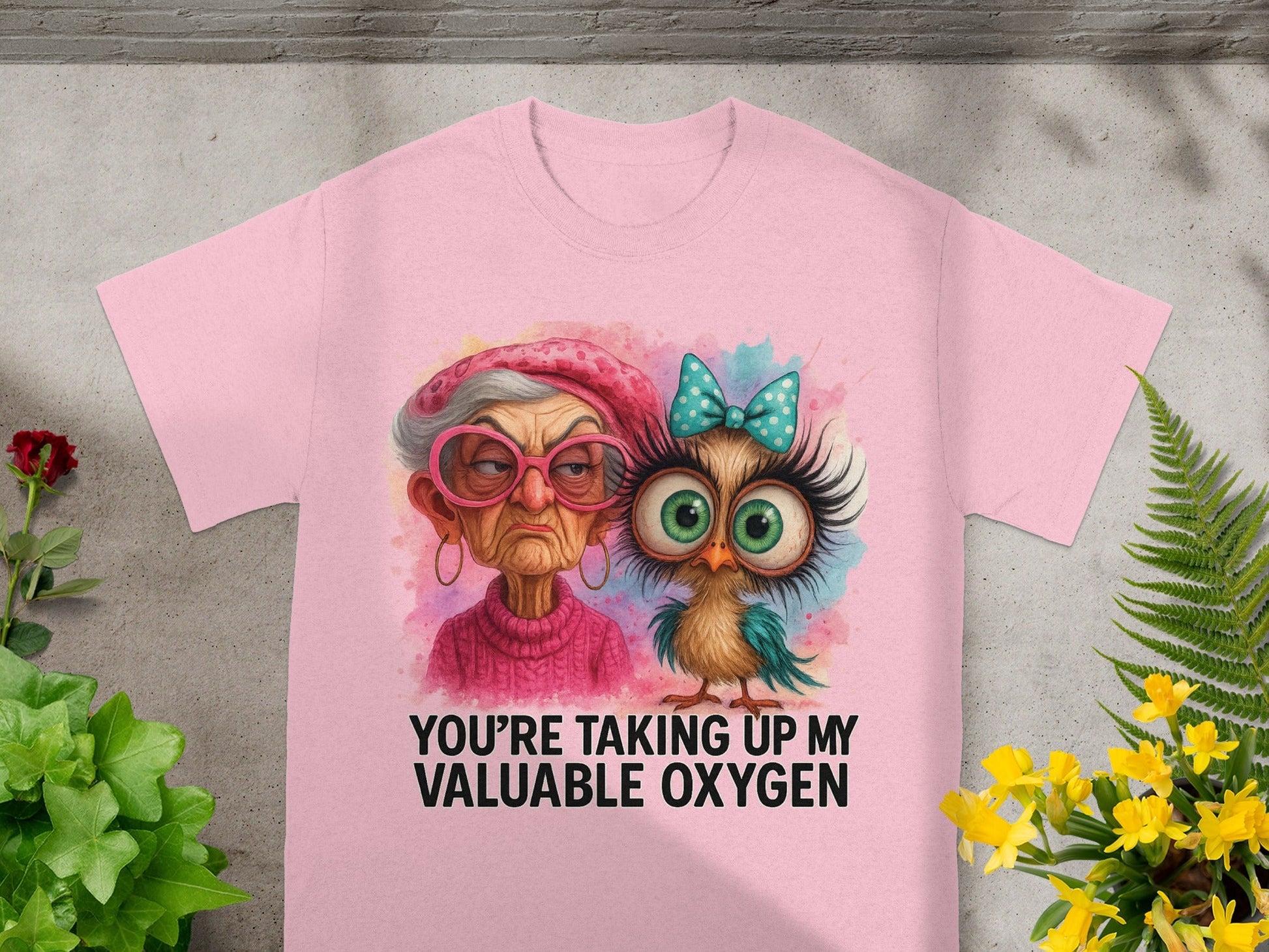 Pink t-shirt with watercolor graphic of an elderly woman and an owl, text says "You're Taking Up My Valuable Oxygen."