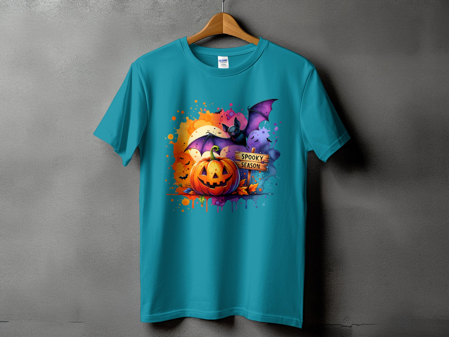 Teal t-shirt with Halloween graphic: jack-o'-lantern, bat, and "Spooky Season" sign.