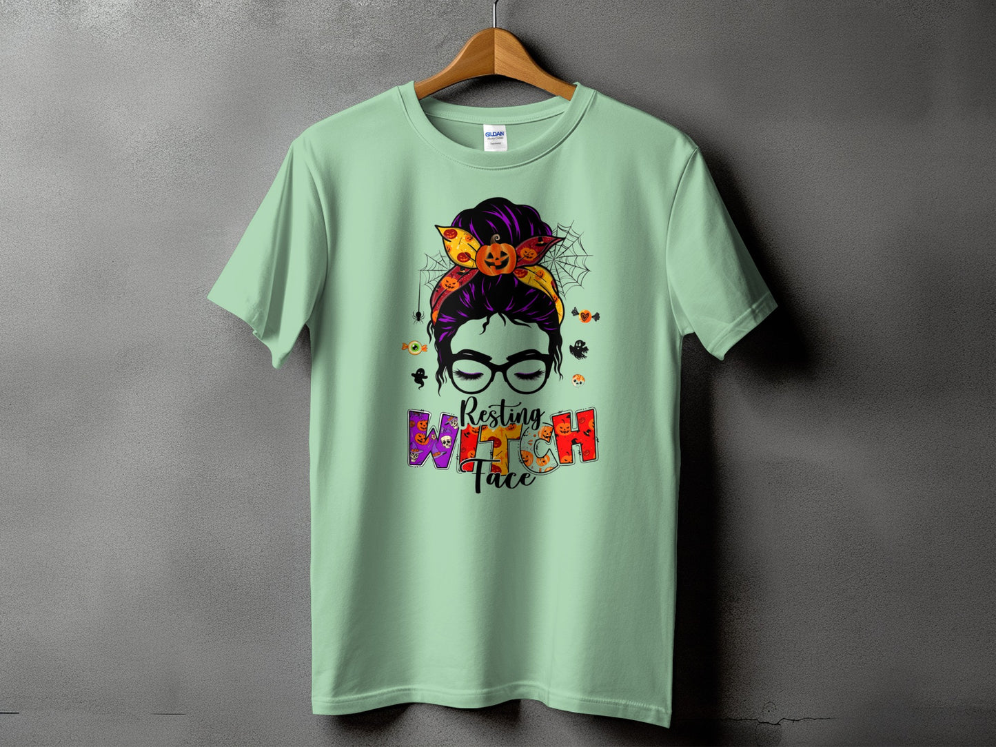 Light green t-shirt with "Resting Witch Face" Halloween graphic.