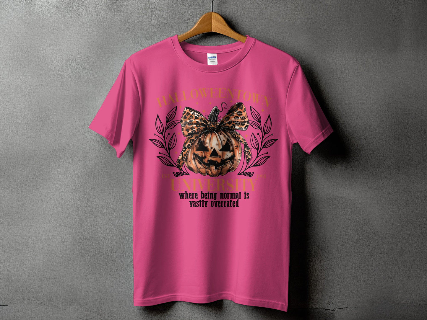 Pink t-shirt with Halloween University graphic featuring a pumpkin and leopard print bow.