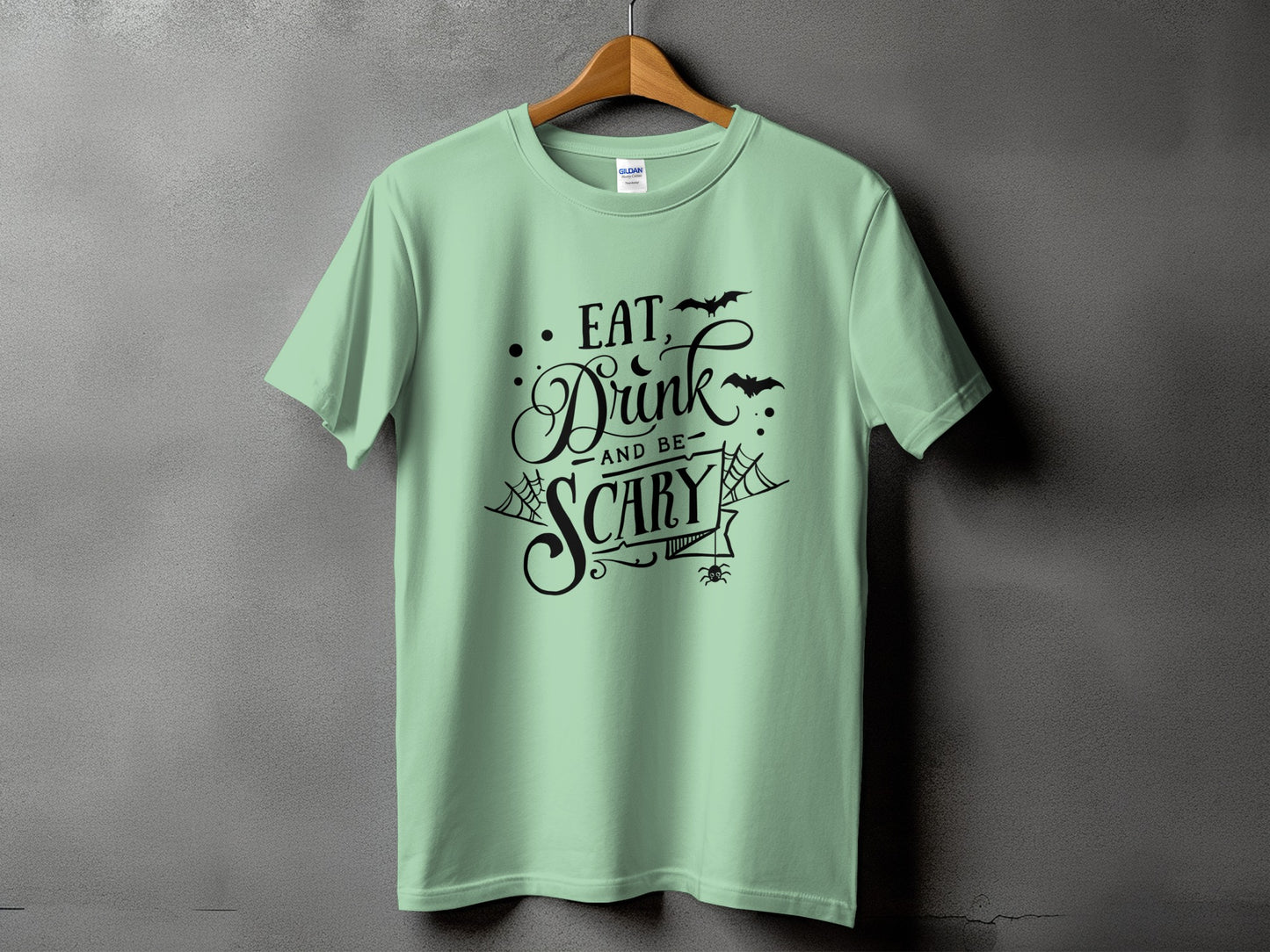 Light green t-shirt with "Eat, Drink and be Scary" Halloween design.