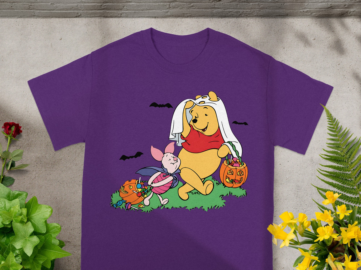 Winnie the Pooh and Piglet in Halloween costumes with pumpkins and candy.