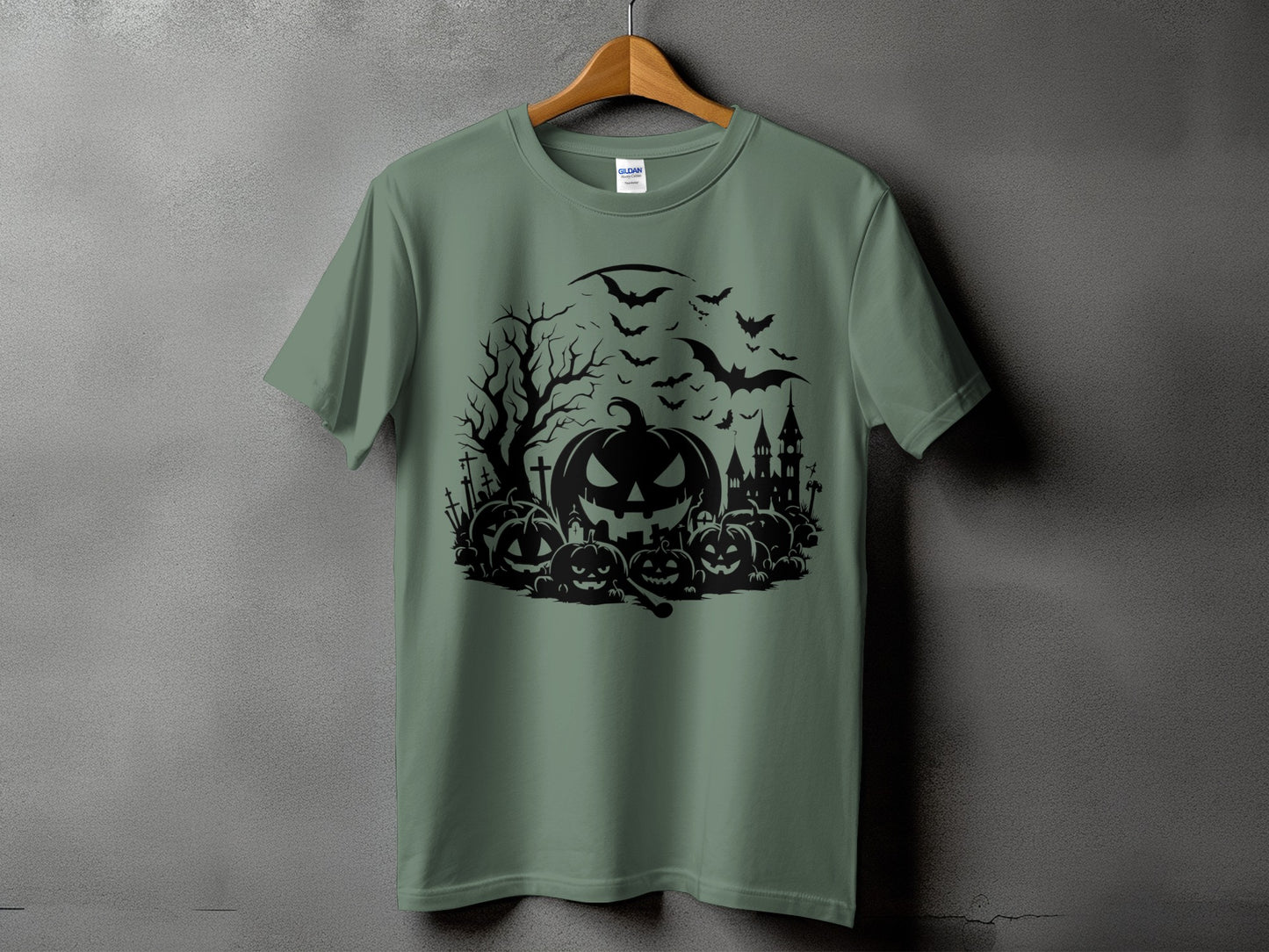 Green t-shirt with black Halloween graphic featuring pumpkins, bats, and a haunted castle.