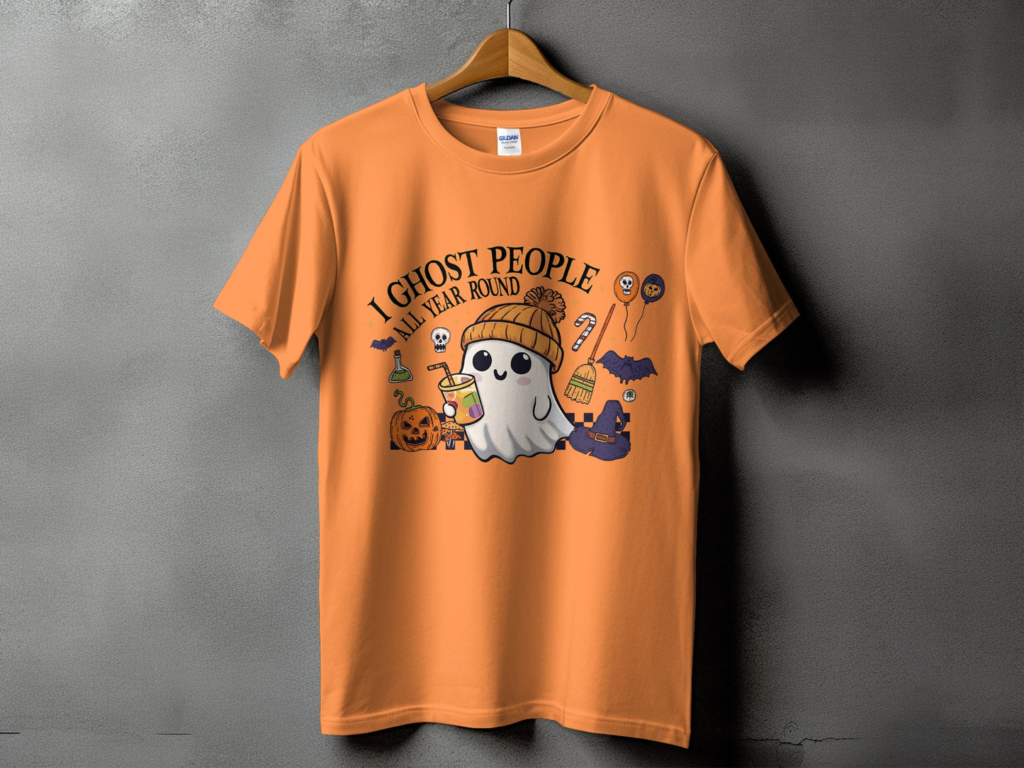 Orange t-shirt with a ghost and Halloween motifs, text "I Ghost People All Year Round".