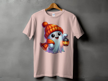 Ghost wearing a winter hat and scarf holds a pumpkin lantern on a pink t-shirt.