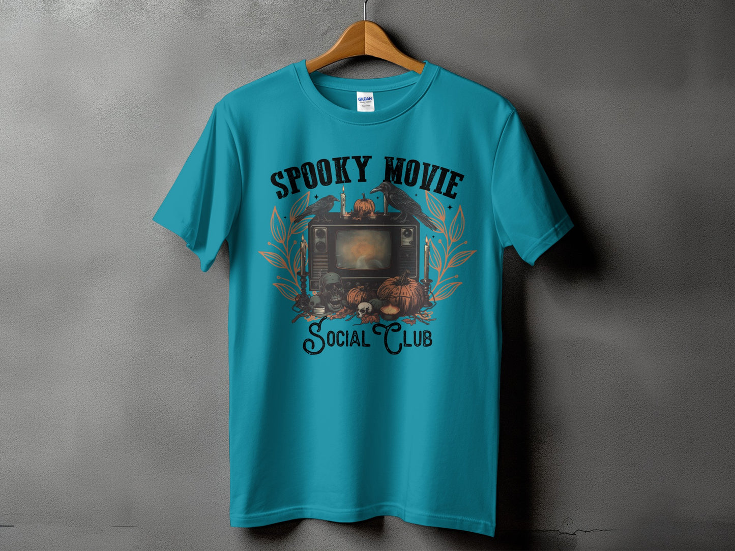 Teal t-shirt with "Spooky Movie Social Club" Halloween graphic.