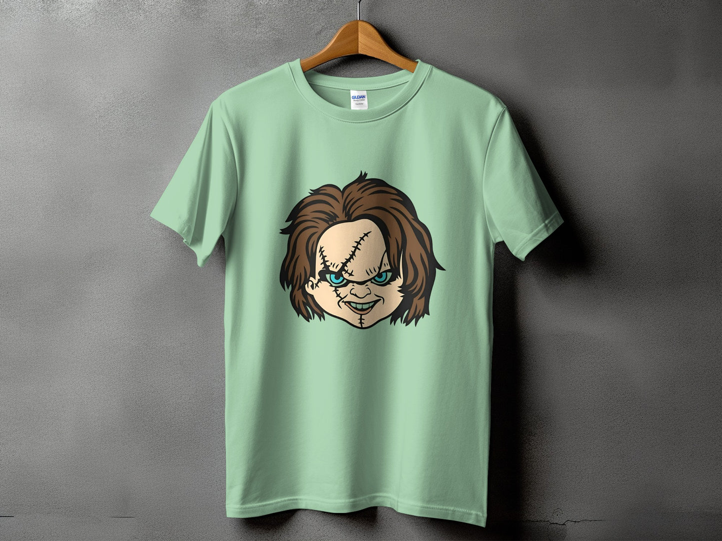 Green t-shirt with Chucky doll face graphic on the front.