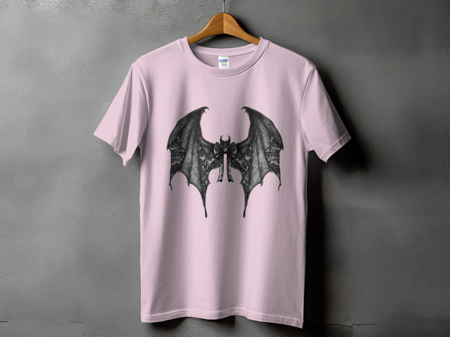Pink t-shirt with a black lace bat wing design and bow.