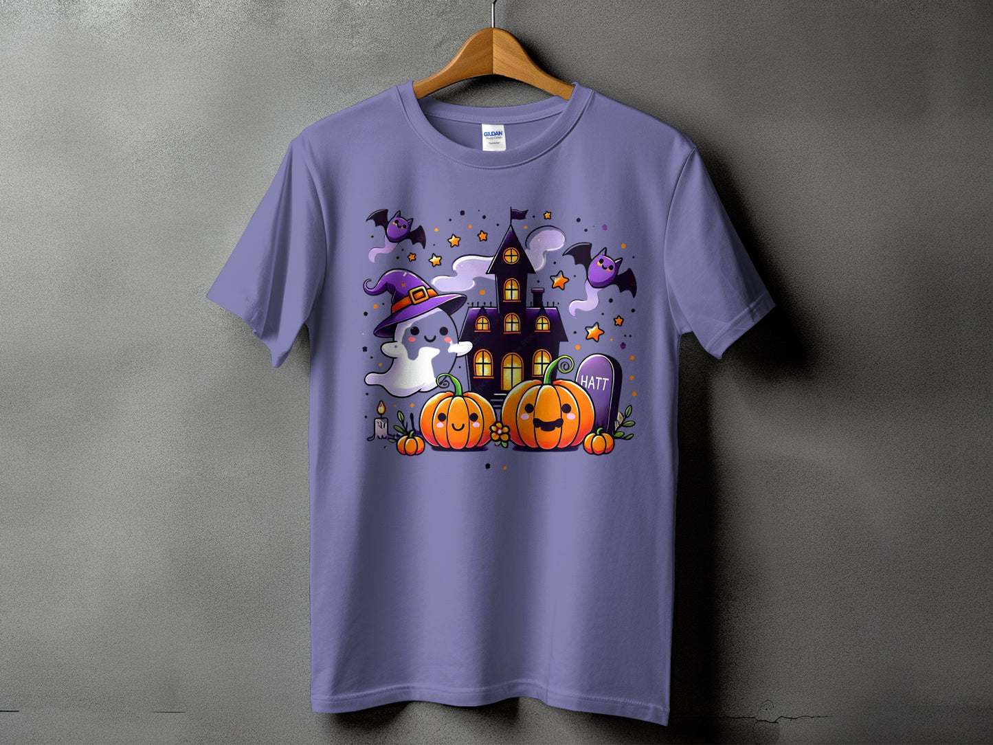 Purple t-shirt with a Halloween-themed graphic featuring ghosts, pumpkins, bats, and a haunted house.