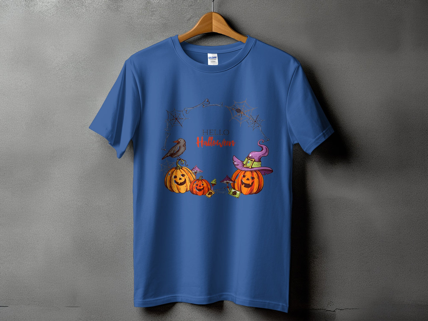 Blue t-shirt with Halloween graphic of pumpkins, a crow, spiderwebs, and text.