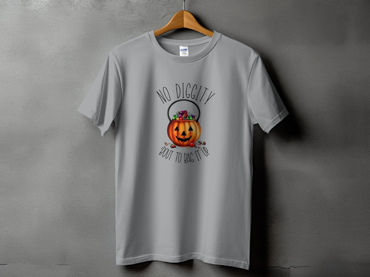 Grey t-shirt with a Halloween pumpkin candy bucket graphic and text.