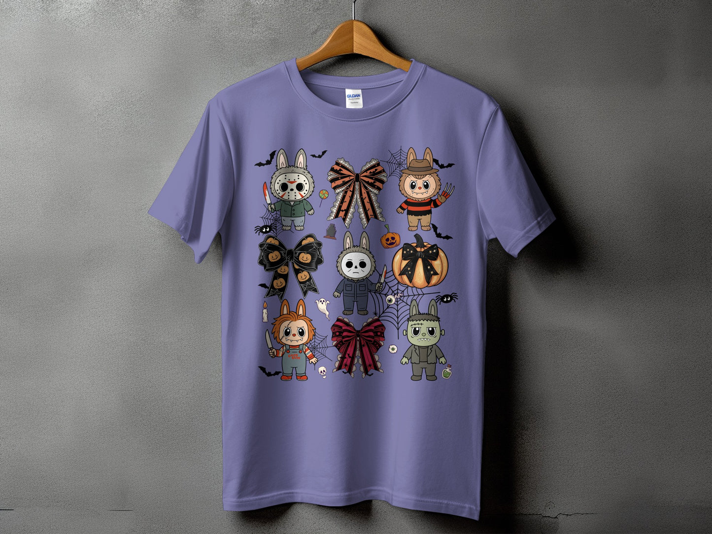 Purple t-shirt with a collage of cute Halloween characters and bows.