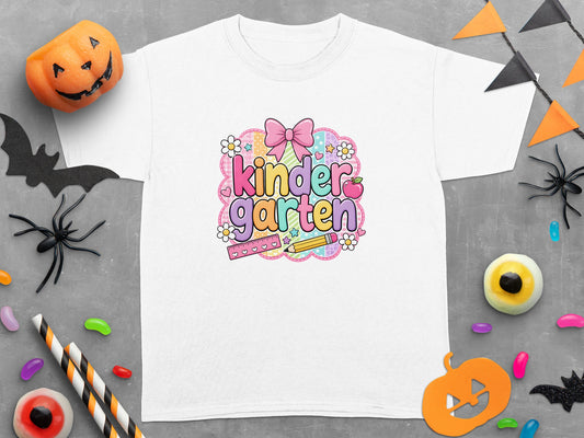 White t-shirt with "Kindergarten" in colorful lettering and Halloween decorations.