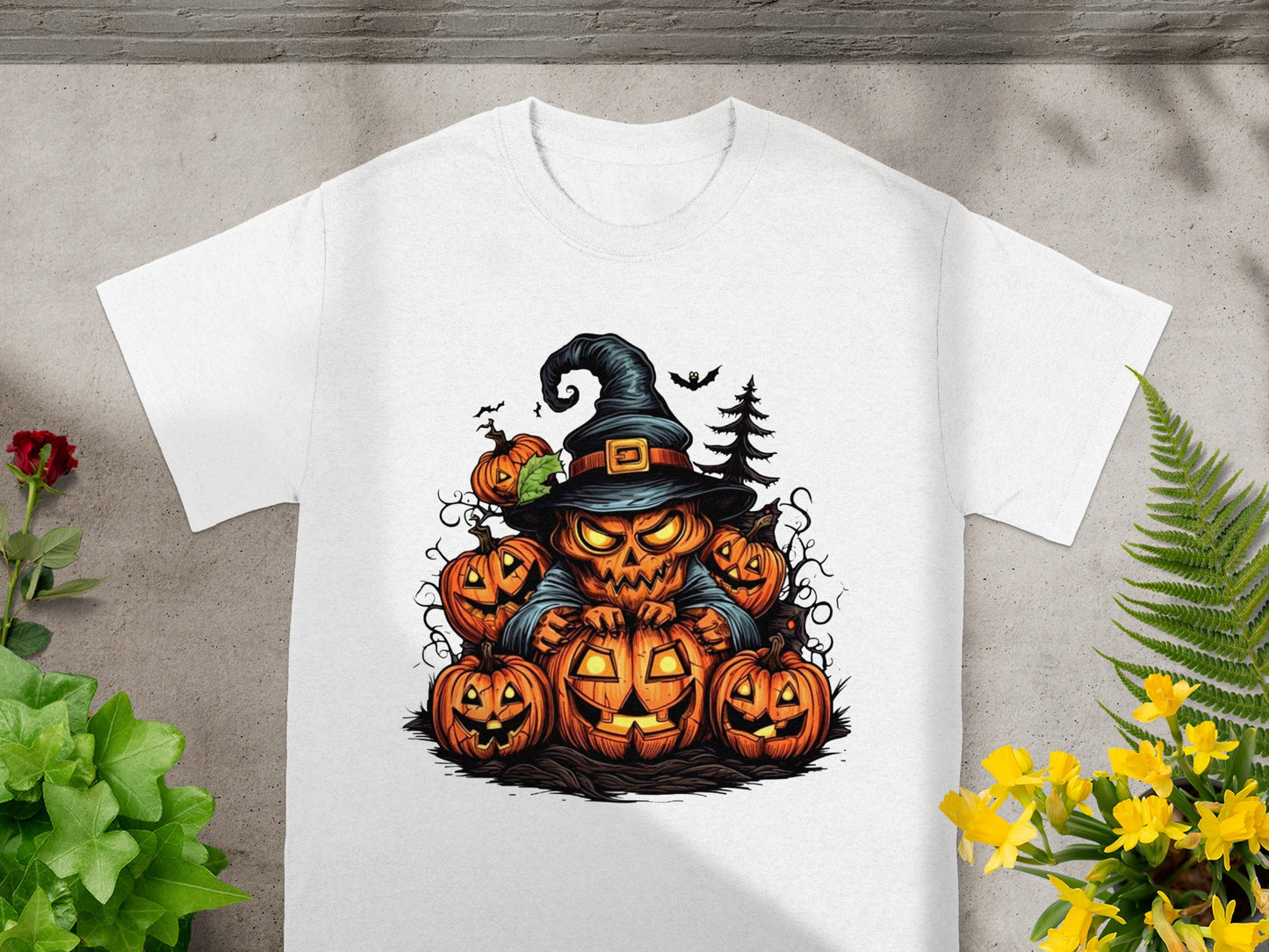 White t-shirt featuring a Halloween graphic with a jack-o'-lantern monster and pumpkins.