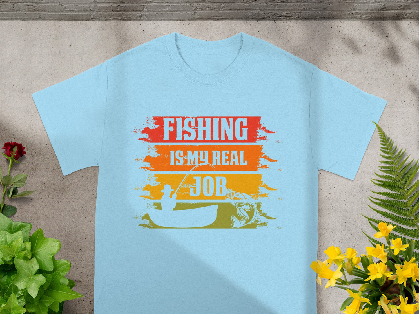 Light blue t-shirt with "FISHING IS MY REAL JOB" graphic and fishing scene.