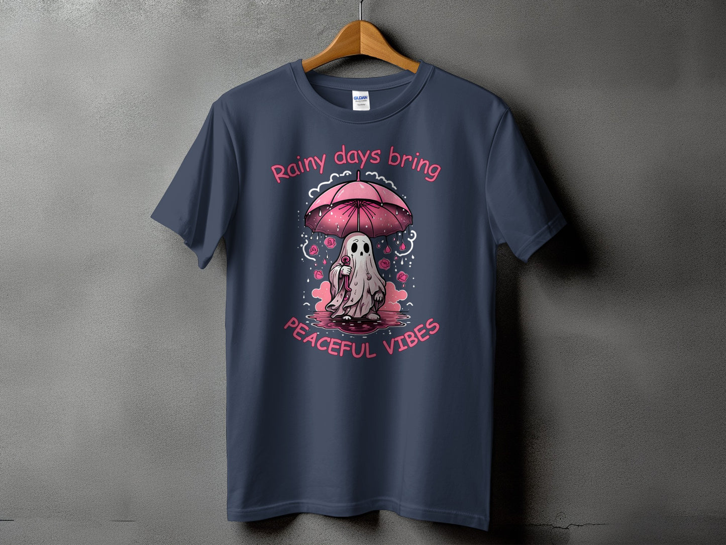 T-shirt with ghost holding umbrella and text "Rainy days bring peaceful vibes."