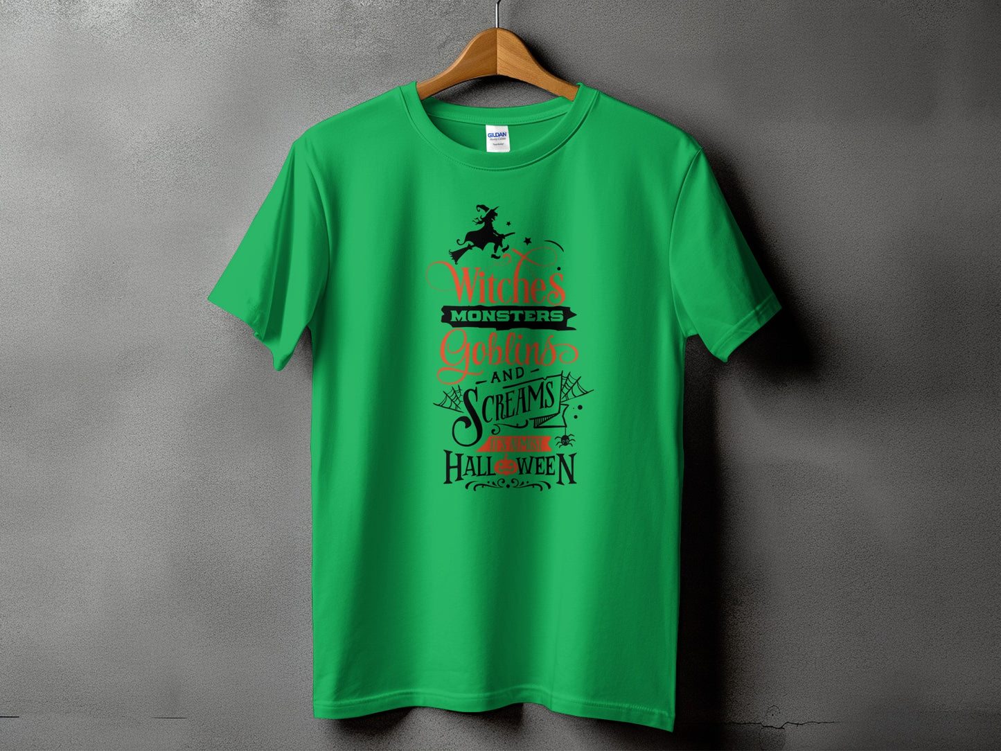 Green t-shirt with Halloween graphic: Witches, Monsters, Goblins, Screams.