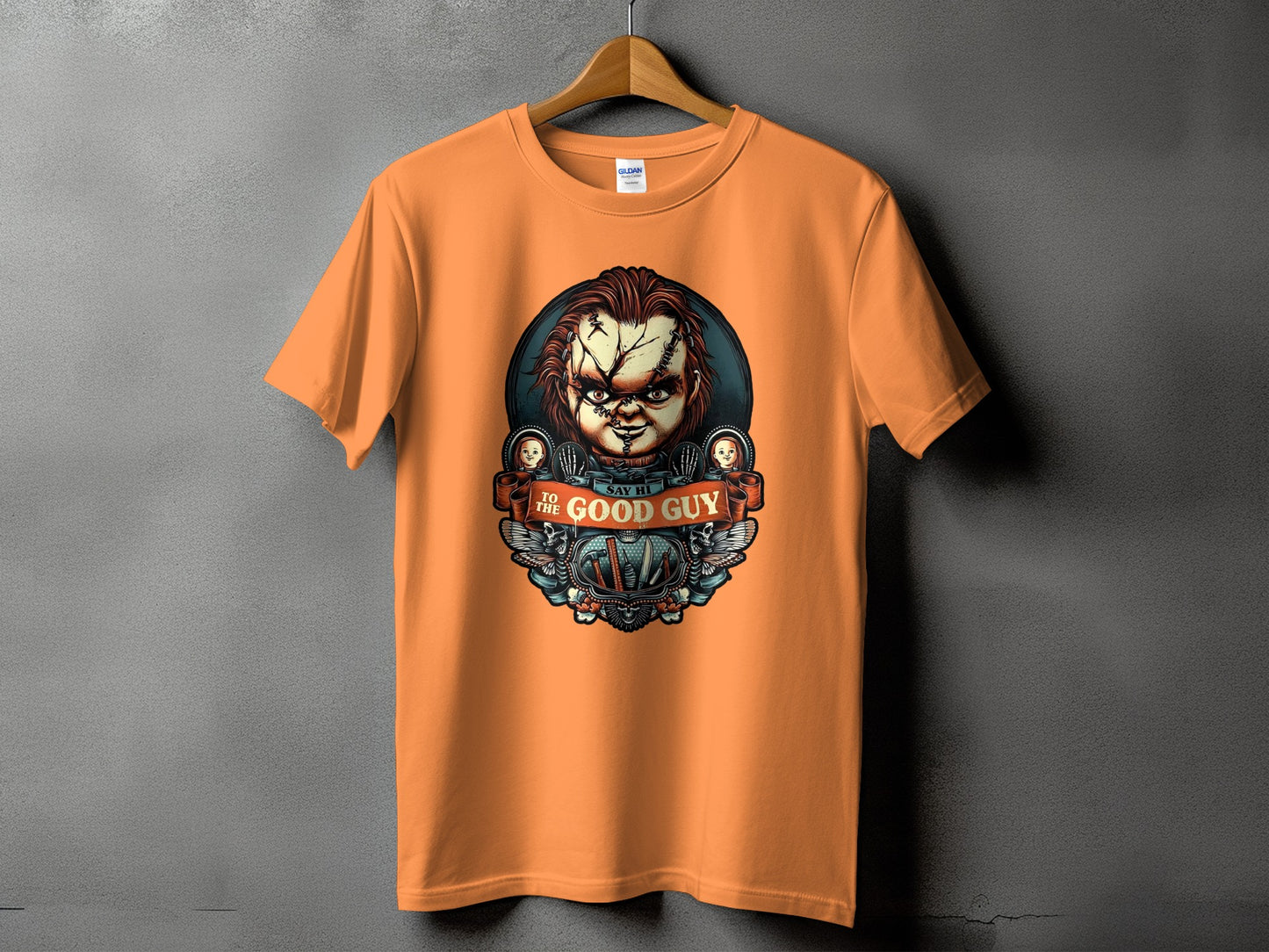 Orange t-shirt with Chucky graphic saying "Say Hi to the Good Guy"