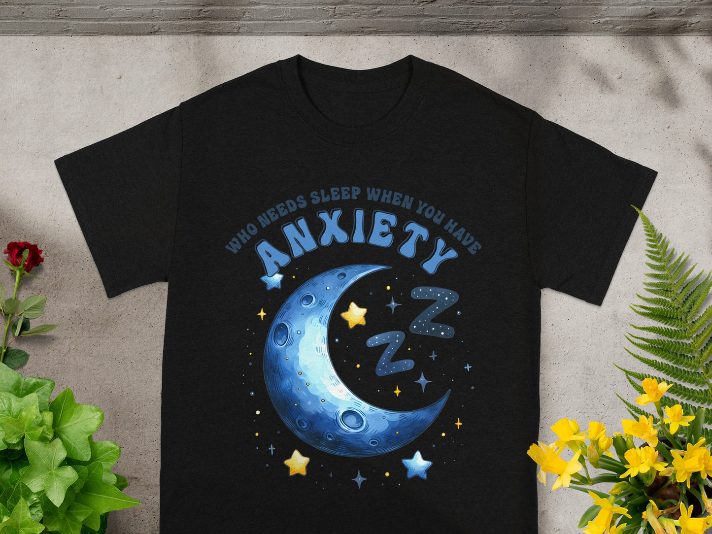 Black t-shirt with text "Who Needs Sleep When You Have Anxiety" and a crescent moon design.