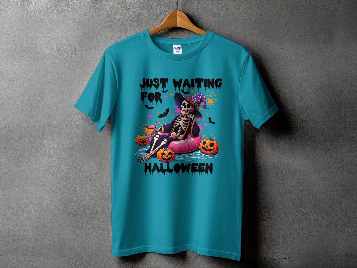 Teal t-shirt with "Just Waiting For Halloween" text and a skeleton in a witch hat.
