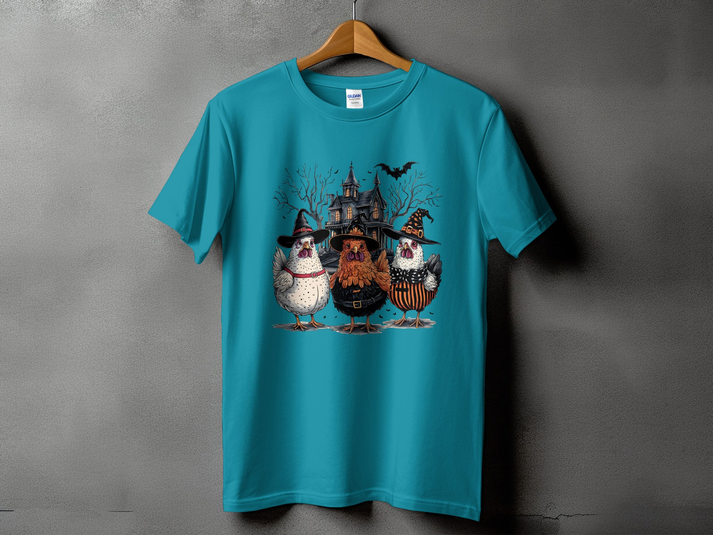 Three chickens in witch hats stand before a haunted house with a bat in the sky.