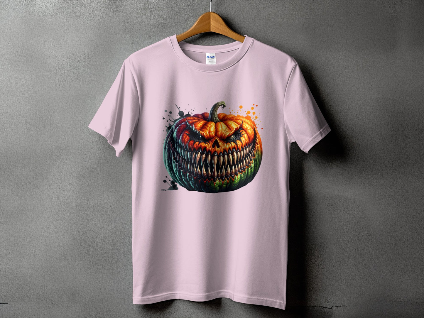 Pink t-shirt featuring a terrifying jack-o'-lantern with sharp teeth and glowing eyes.
