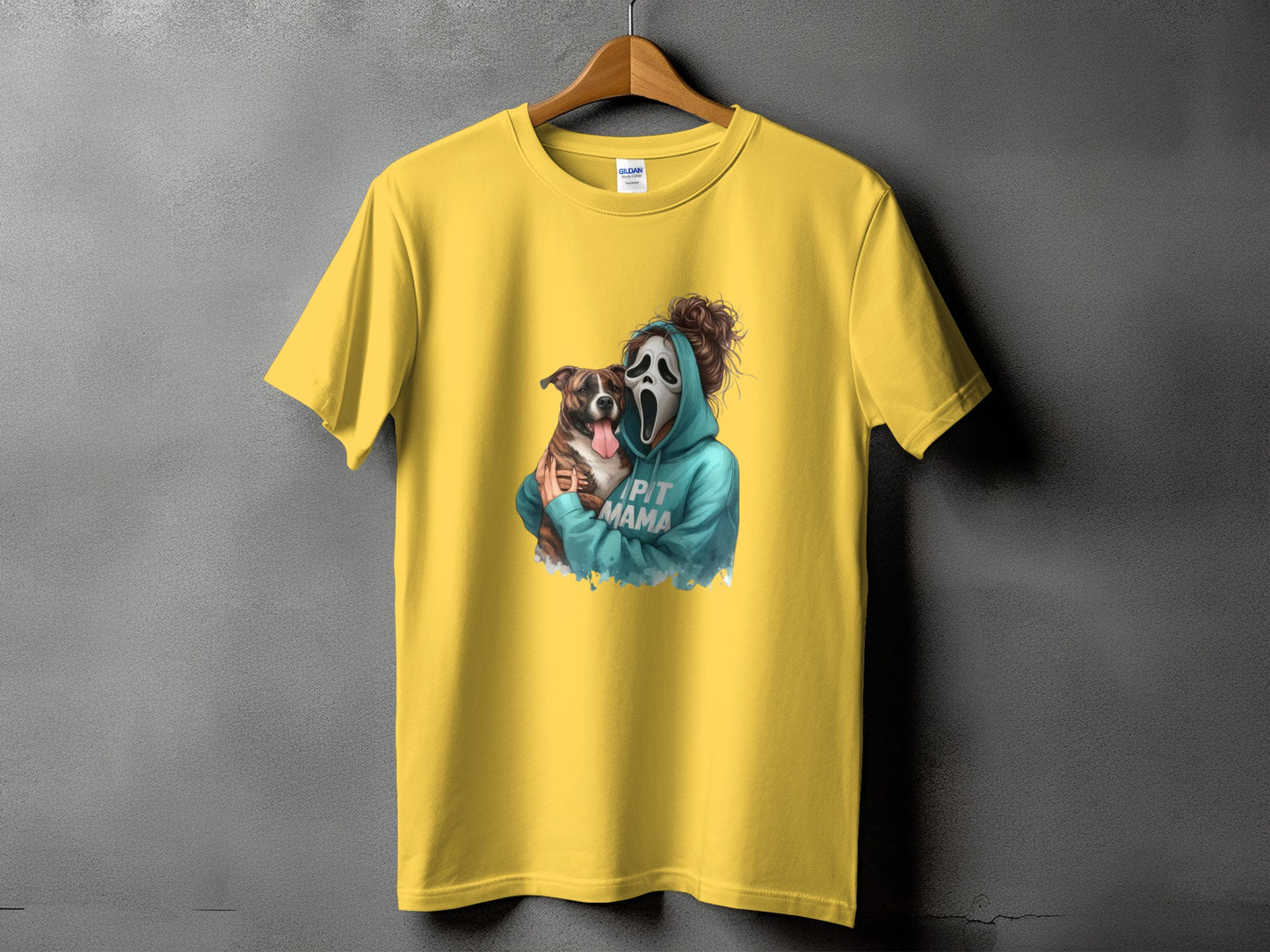 Yellow t-shirt featuring a graphic of a person in a Ghostface mask holding a pitbull and text "PIT MAMA".