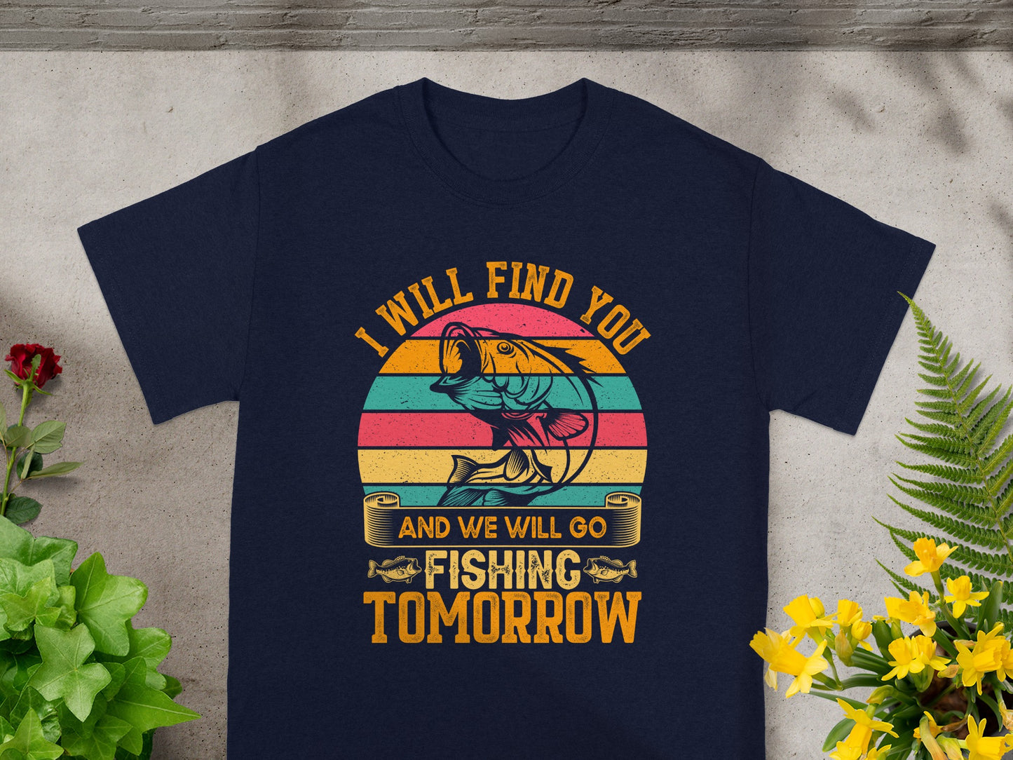 Navy t-shirt with a graphic featuring a bass fish, text "I WILL FIND YOU" and "AND WE WILL GO FISHING TOMORROW".