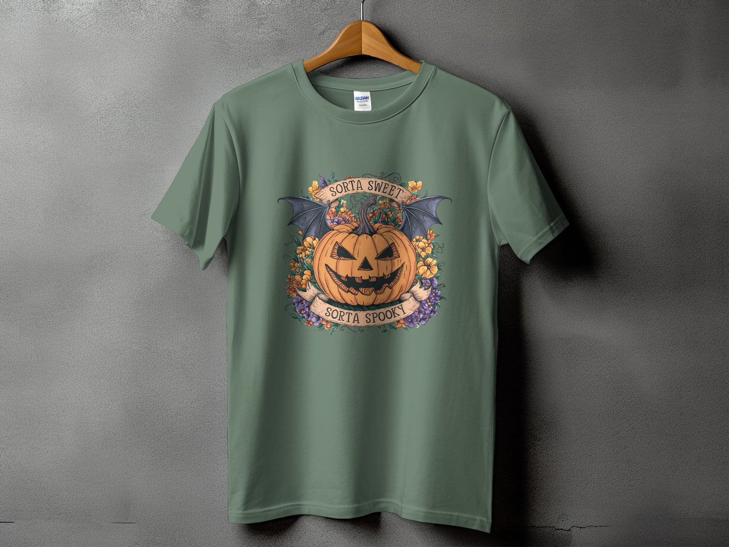 T-shirt with a Halloween graphic of a jack-o'-lantern, bat wings, and flowers.