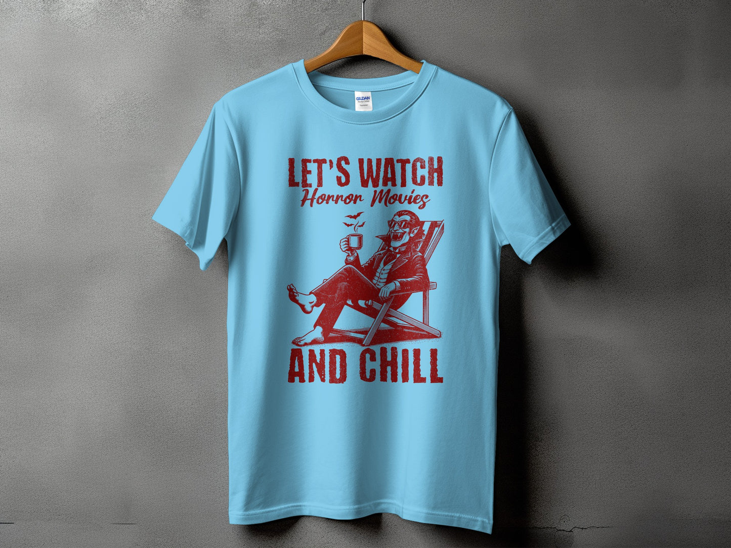 Light blue t-shirt with red graphic text "LET'S WATCH Horror Movies AND CHILL".