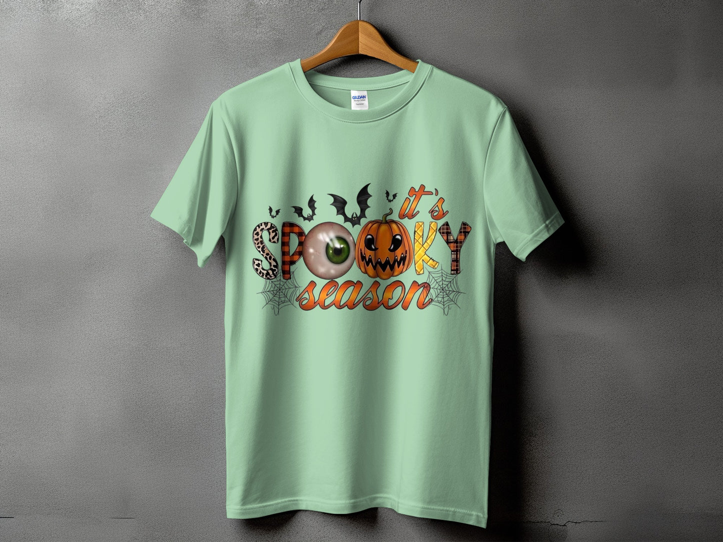 Mint green t-shirt with "it's SPOOKY season" Halloween graphic.